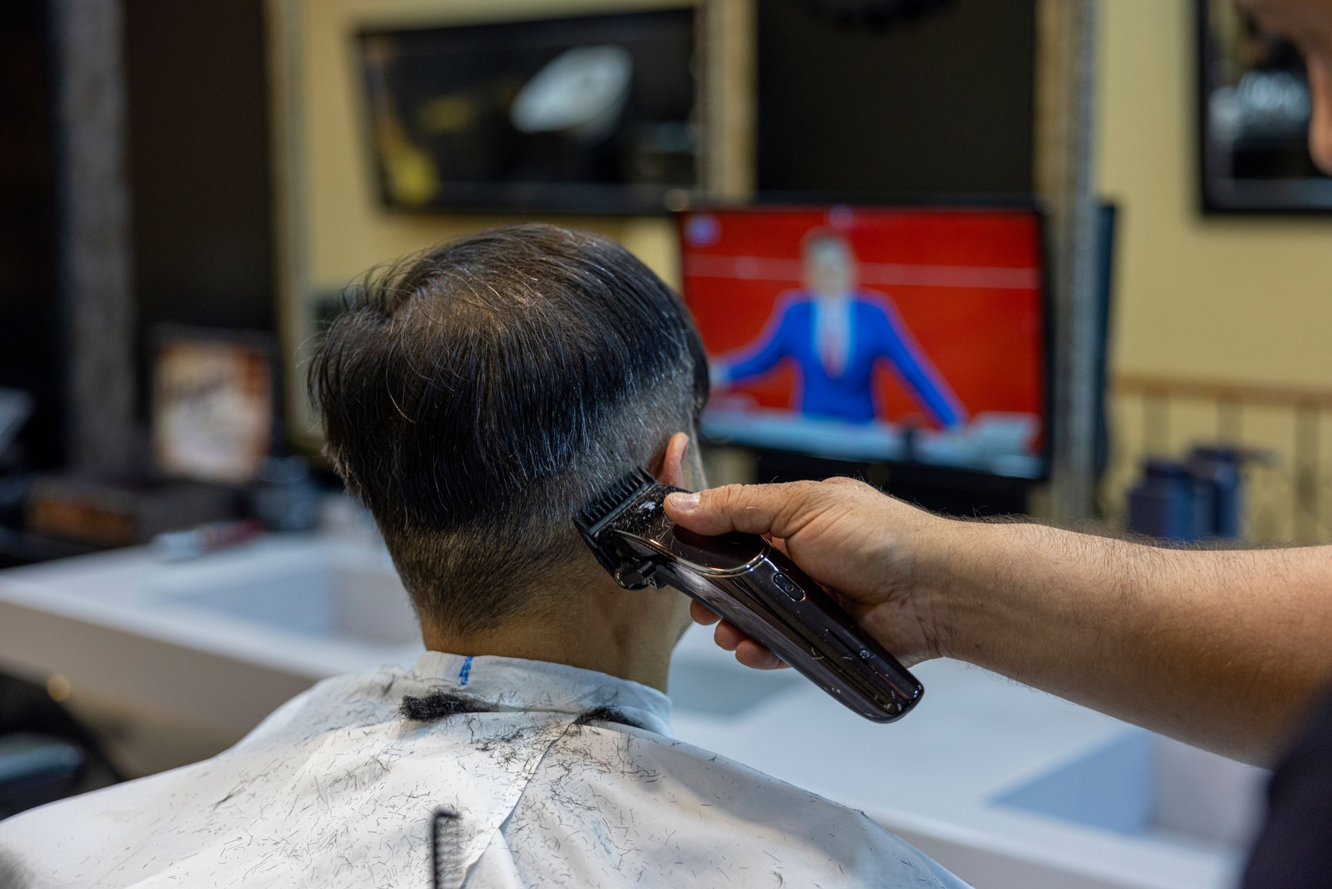 A man getting his hair cut at the barber